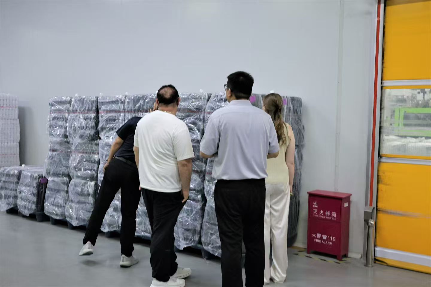 Client inspecting pallets of finished goods in Zuoning warehouse